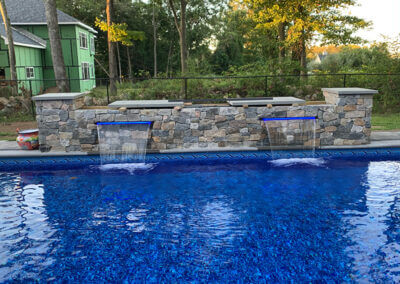 Rock wall with lighted water sheers
